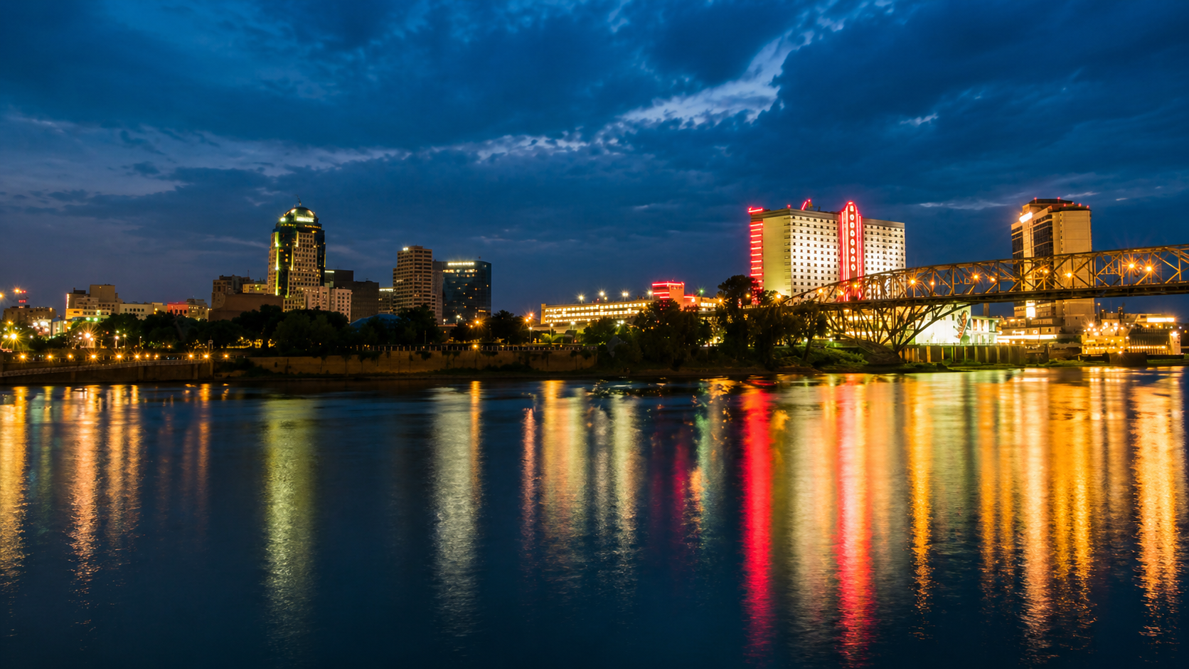 A Louisiana skyline at dusk reflected on the river